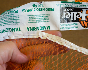 Cut the label off of the plastic mesh bag