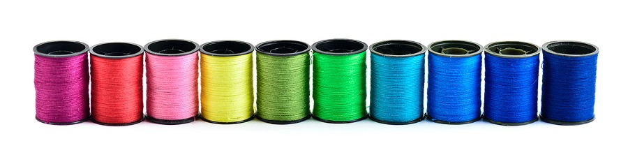 Sewing threads multicolored at white background