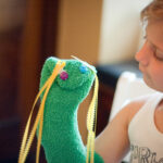 child with hand puppet