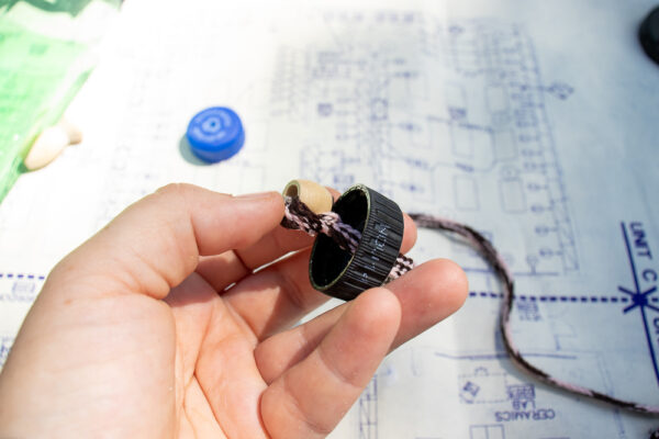 Knot the cord inside the cap.
